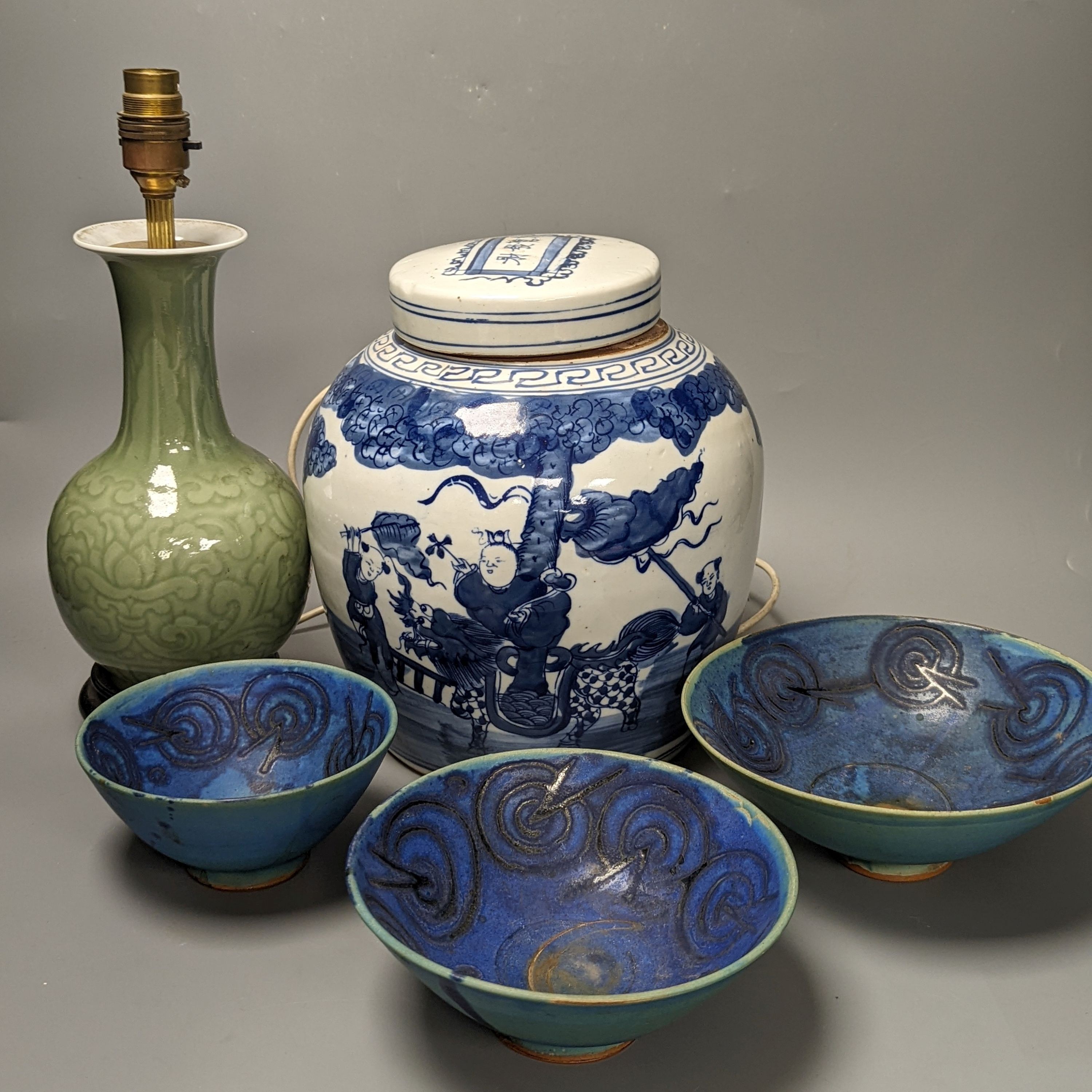 A Chinese blue and white jar and cover, 25 cm high and a celadon glazed lamp